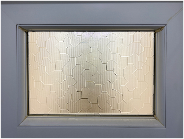 Kleines Kunststofffenster mit Sichtschutzglas und geometrischem Muster