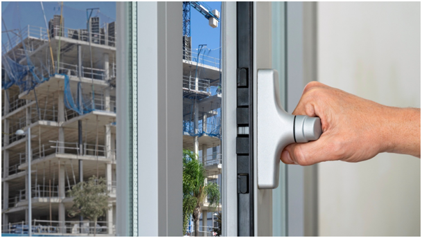 Handöffnung eines Schallschutzfensters in der Nähe einer Baustelle