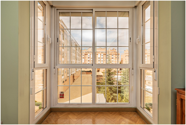 Alt-Attribut: Große Fensterfront einer Wohnung mit Blick auf andere Gebäude.